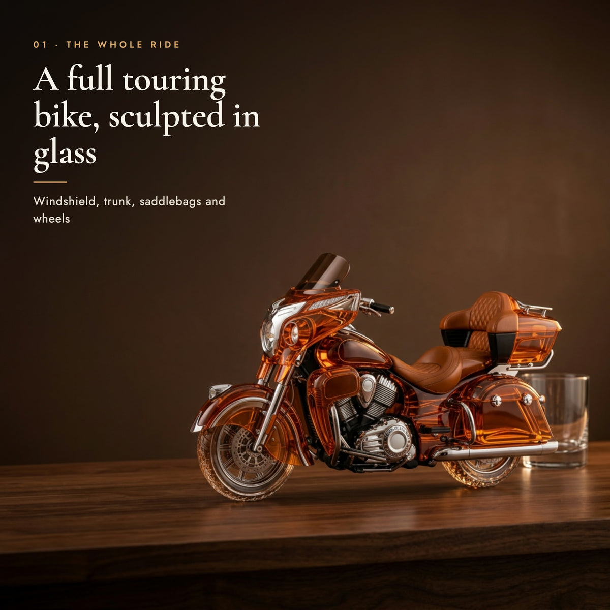 Glass decanter shaped as a full touring motorcycle on a dark walnut bar top