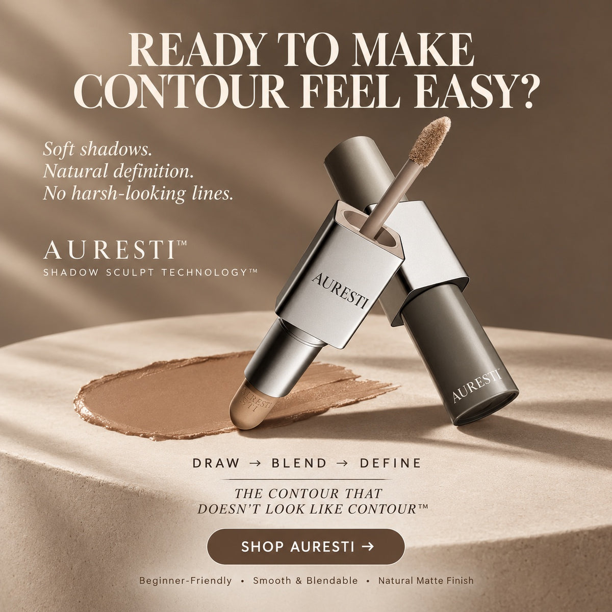 Dual-ended contour stick on a beige stone plinth with a tan cream swatch in warm studio light