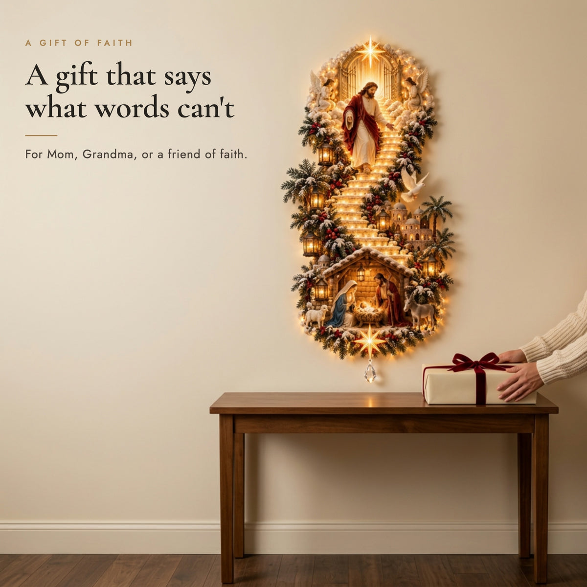 Hands placing a wrapped Christmas gift on a console beside the glowing Jesus wall hanging